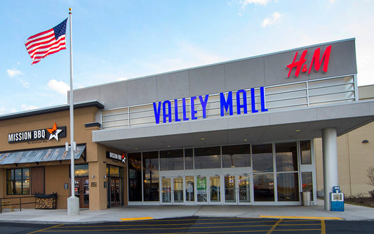 Valley Mall entrance with H&M store and American flag on a clear day